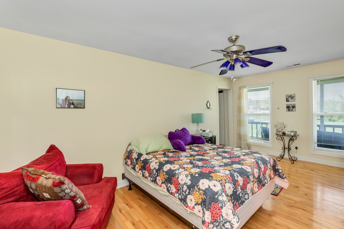 28140 Mitchell Road Ardmore, AL 35739 - Photo 11 of 24 a bedroom with a bed and a chandelier