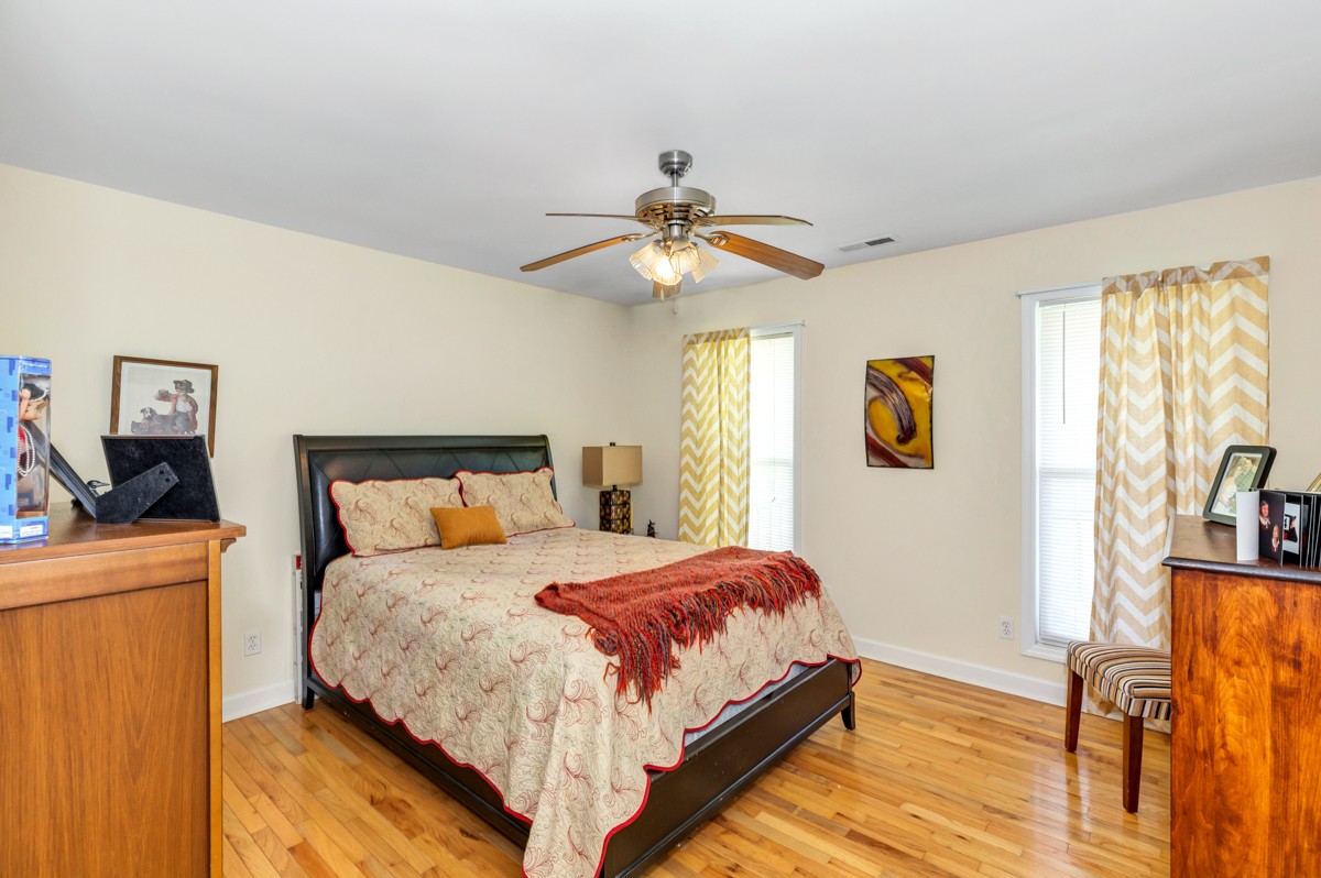 28140 Mitchell Road Ardmore, AL 35739 - Photo 15 of 24 a bedroom with a bed and a chandelier
