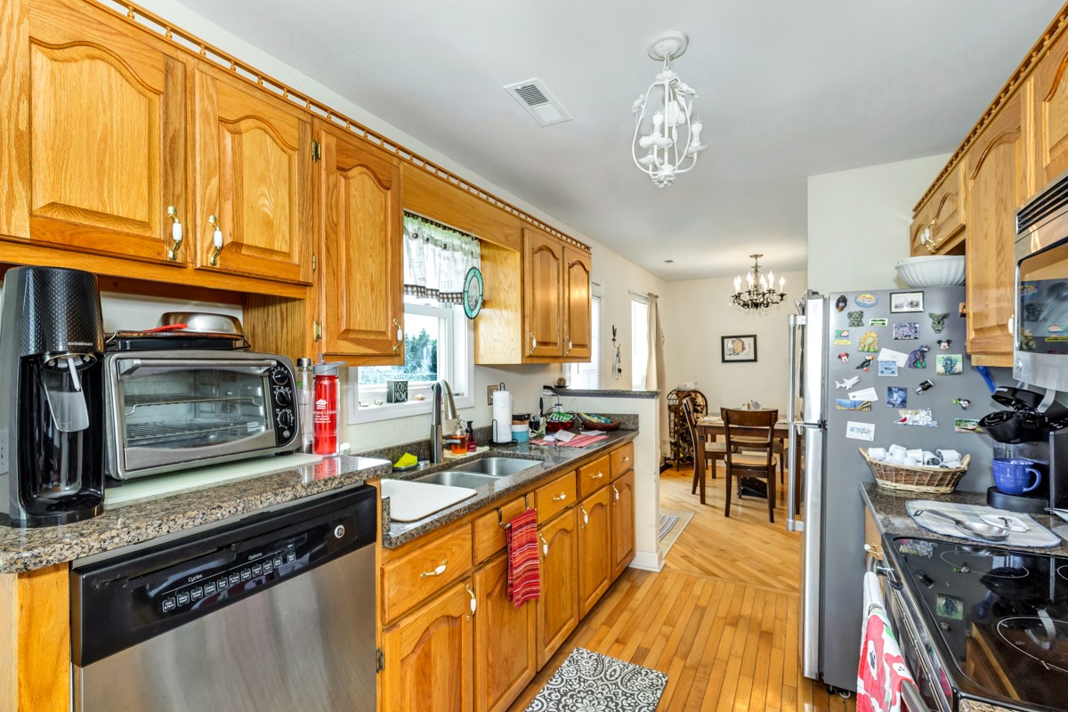 28140 Mitchell Road Ardmore, AL 35739 - Photo 8 of 24 a kitchen with stainless steel appliances granite countertop a stove a sink dishwasher and a microwave oven with cabinets