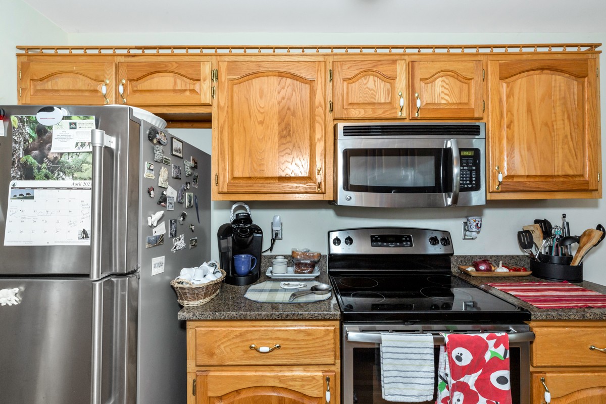 28140 Mitchell Road Ardmore, AL 35739 - Photo 9 of 24 a kitchen with stainless steel appliances granite countertop a stove and a refrigerator