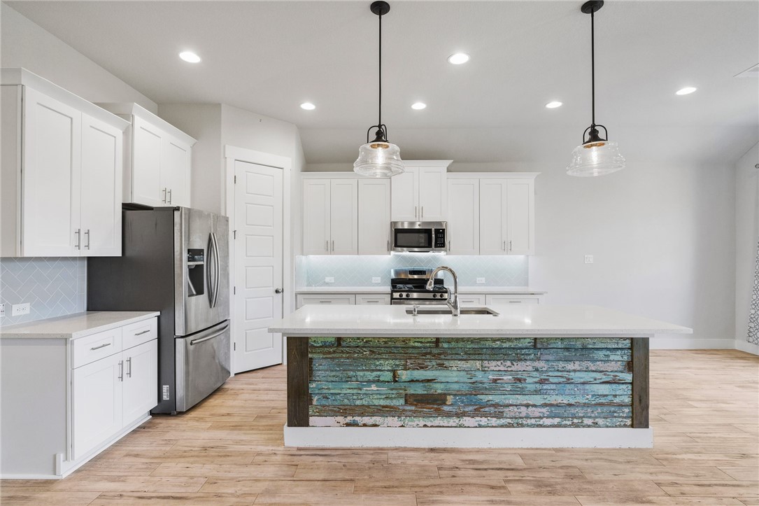941 Del Raphael Drive Leander, TX 78641 - Photo 9 of 33 Deep drawers and smart cabinet placement mean everything has a home, keeping the counters clutter-free