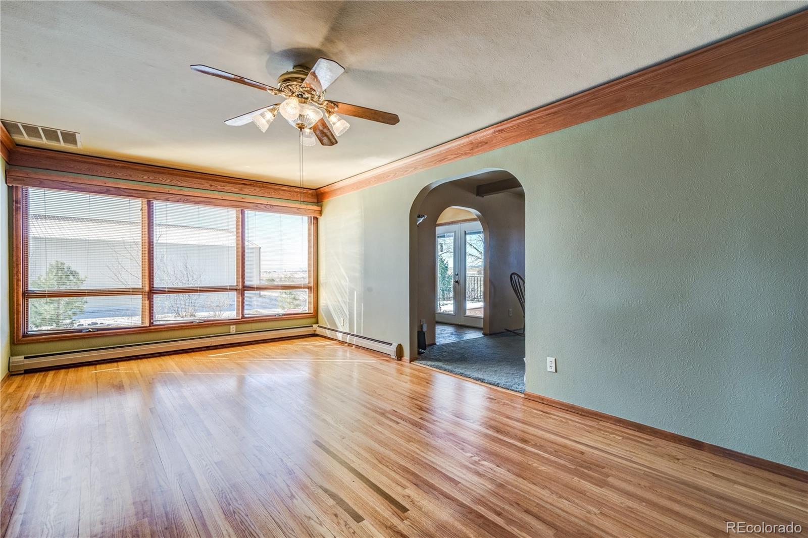 16065 Jones Road Peyton, CO 80831 - Photo 11 of 29 a view of empty room with wooden floor and fan