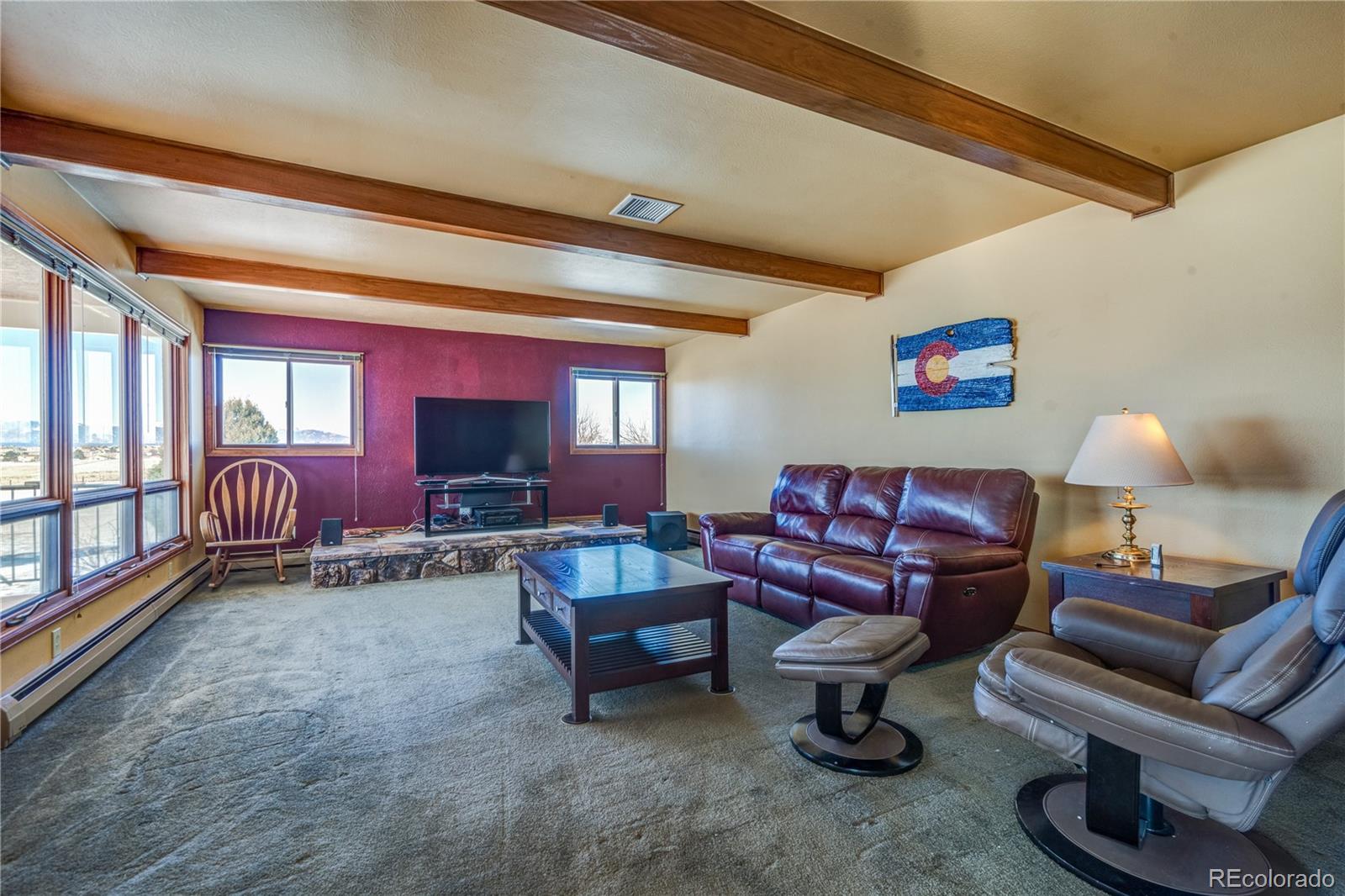 16065 Jones Road Peyton, CO 80831 - Photo 12 of 29 a living room with furniture and a flat screen tv