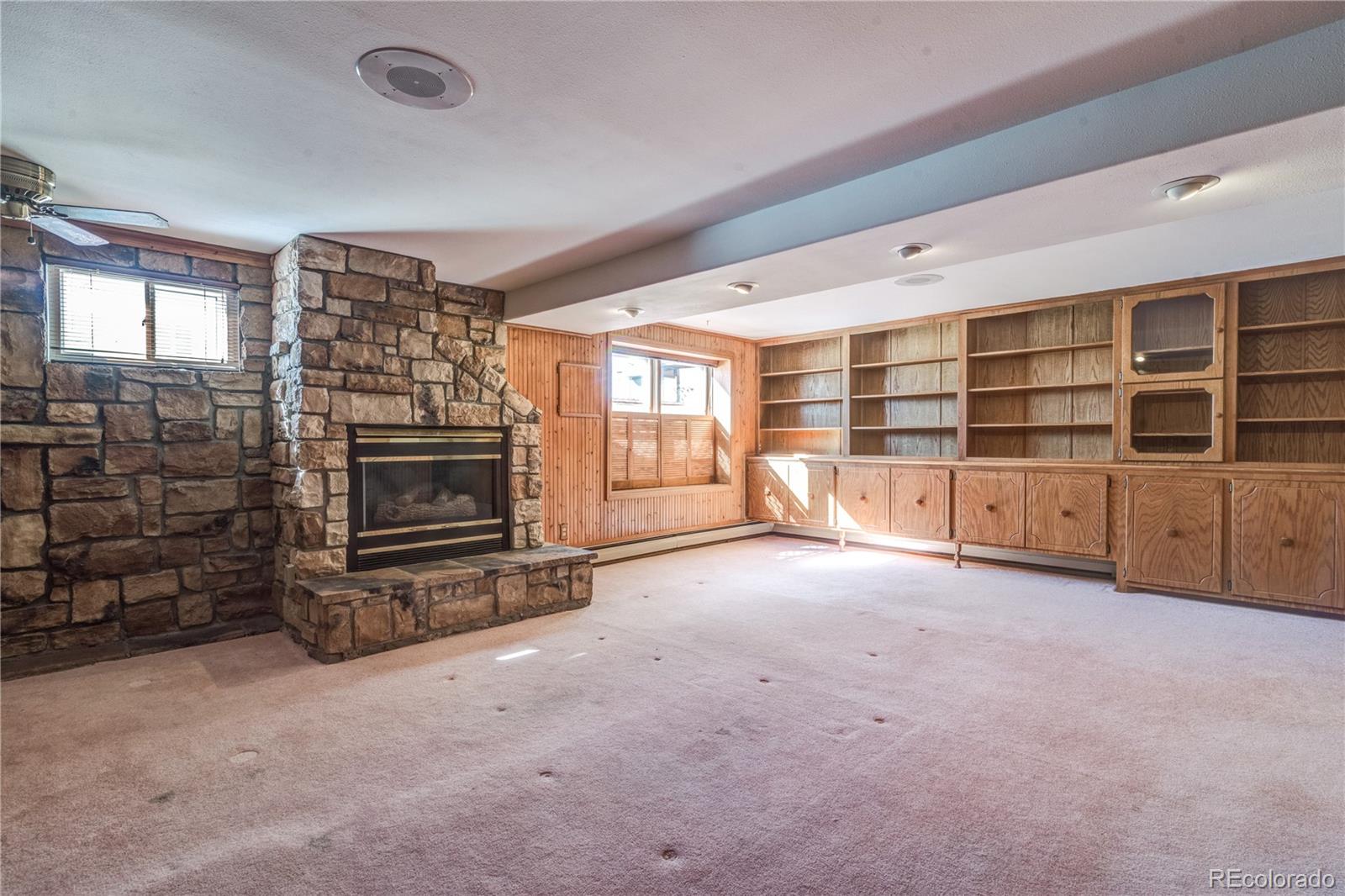 16065 Jones Road Peyton, CO 80831 - Photo 20 of 29 a view of an empty room with a fireplace and windows