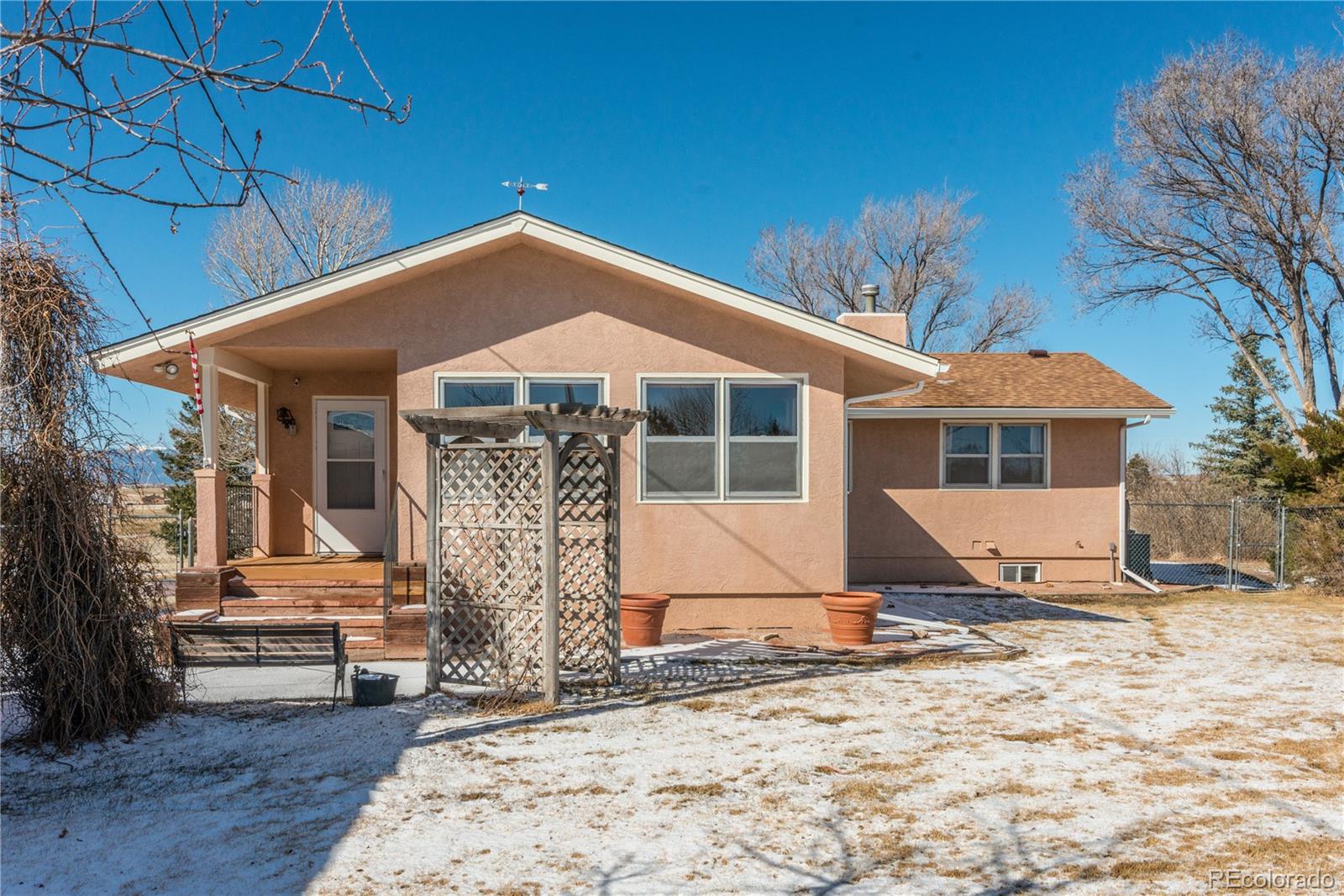 16065 Jones Road Peyton, CO 80831 - Photo 2 of 29 a front view of a house with glass windows