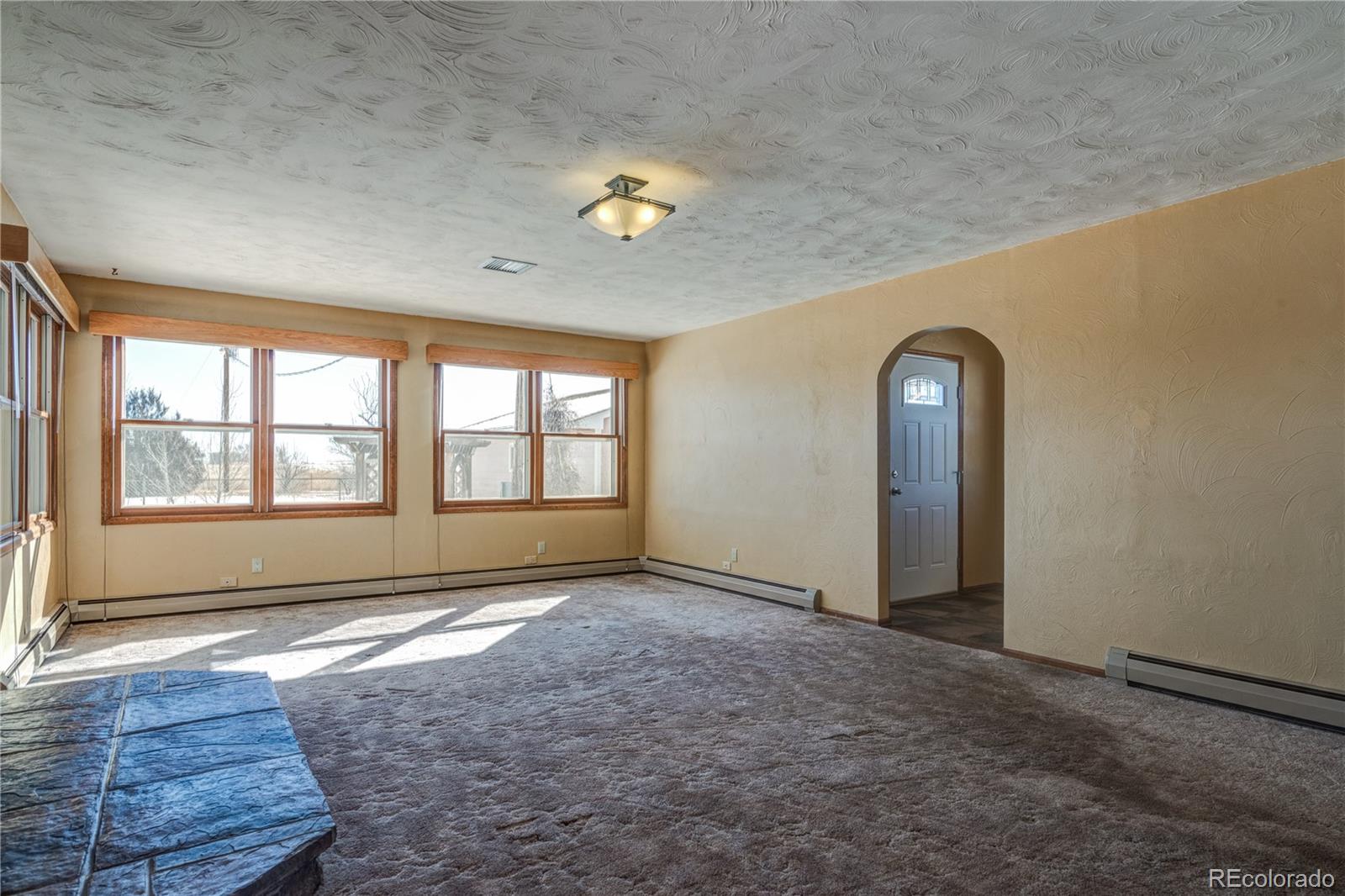 16065 Jones Road Peyton, CO 80831 - Photo 6 of 29 an empty room with windows