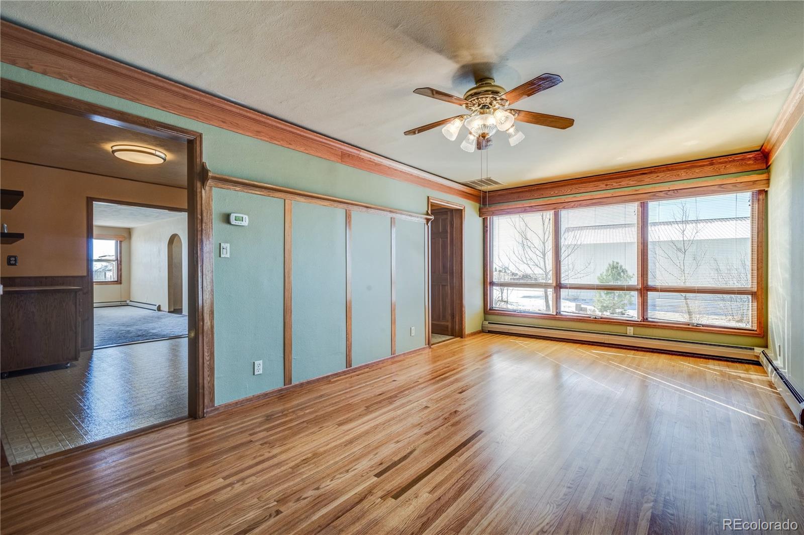 16065 Jones Road Peyton, CO 80831 - Photo 10 of 29 a view of empty room with wooden floor and fan