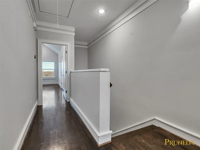 a view of hallway with wooden floor