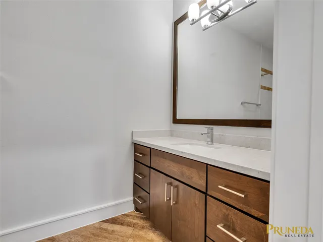 a bathroom with a sink and a mirror