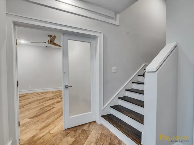 a view of a hallway with closet and wooden floor