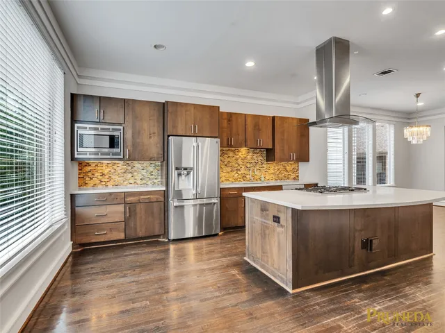 a kitchen with stainless steel appliances a stove and refrigerator