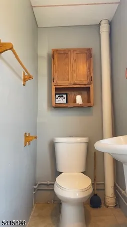 a white toilet sitting next to a bathroom sink