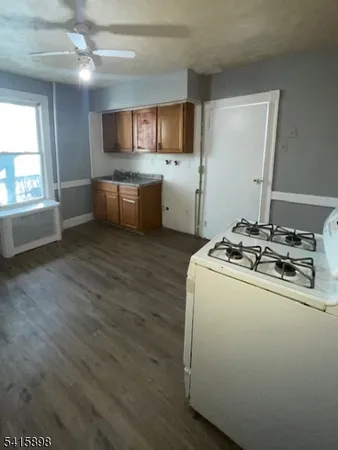 a kitchen with a sink appliances and cabinets