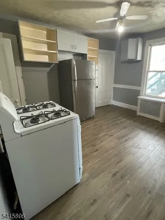 a kitchen with stainless steel appliances granite countertop a refrigerator a sink and a stove