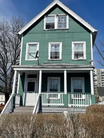 a front view of a house with a small yard