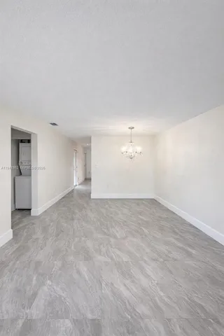 an empty room with a empty space and windows