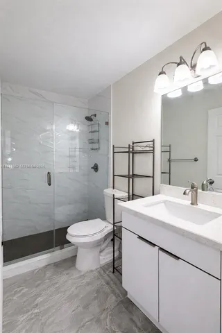 a bathroom with a sink toilet and shower