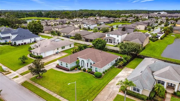 an aerial view of multiple houses with yard