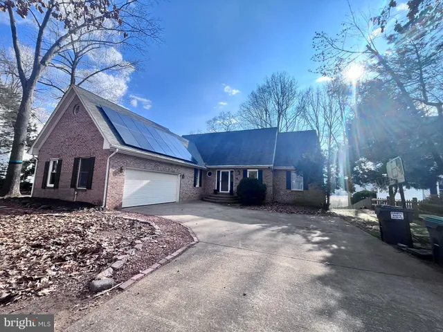 a house that has a tree in front of it