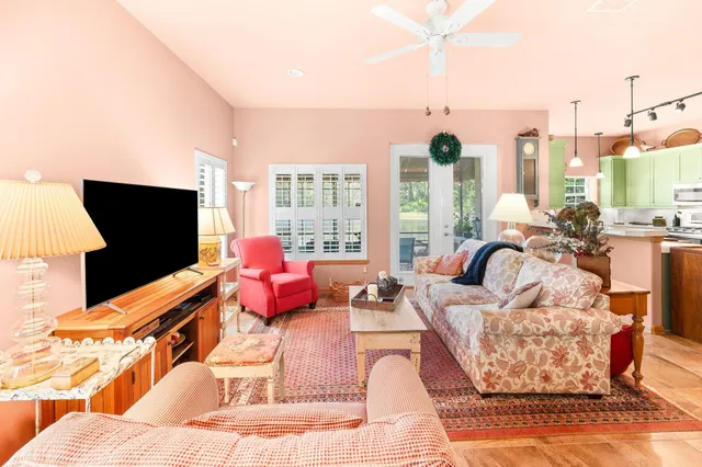 a living room with furniture large window and flat screen tv