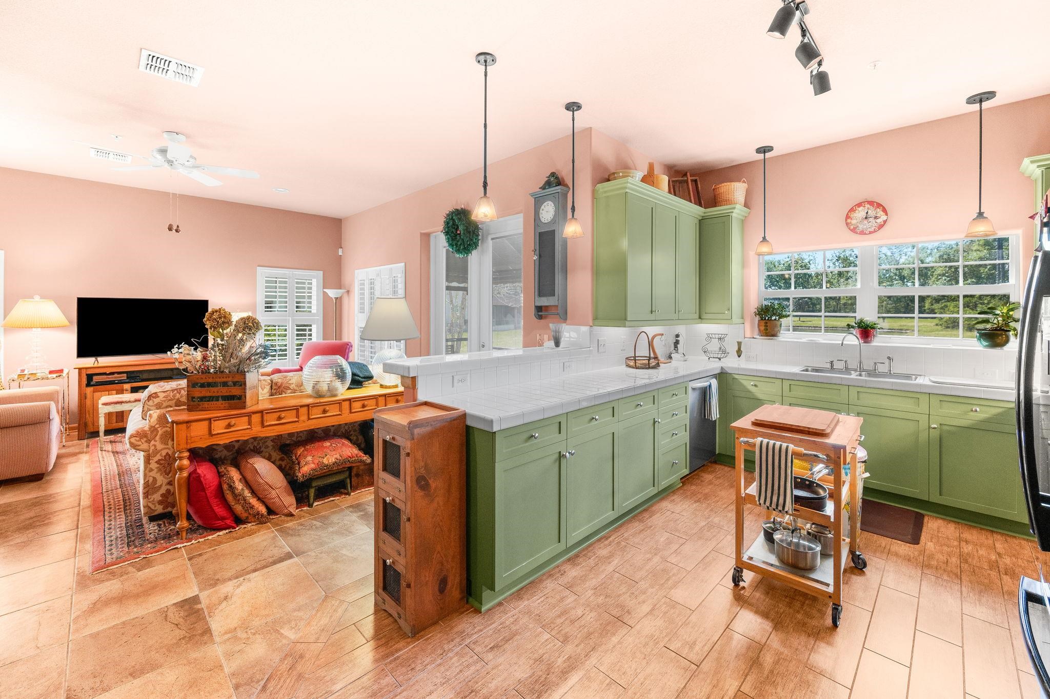 99 Grand Ravine Drive St. Augustine, FL 32086 - Photo 16 of 42 a kitchen with a sink cabinets and wooden floor