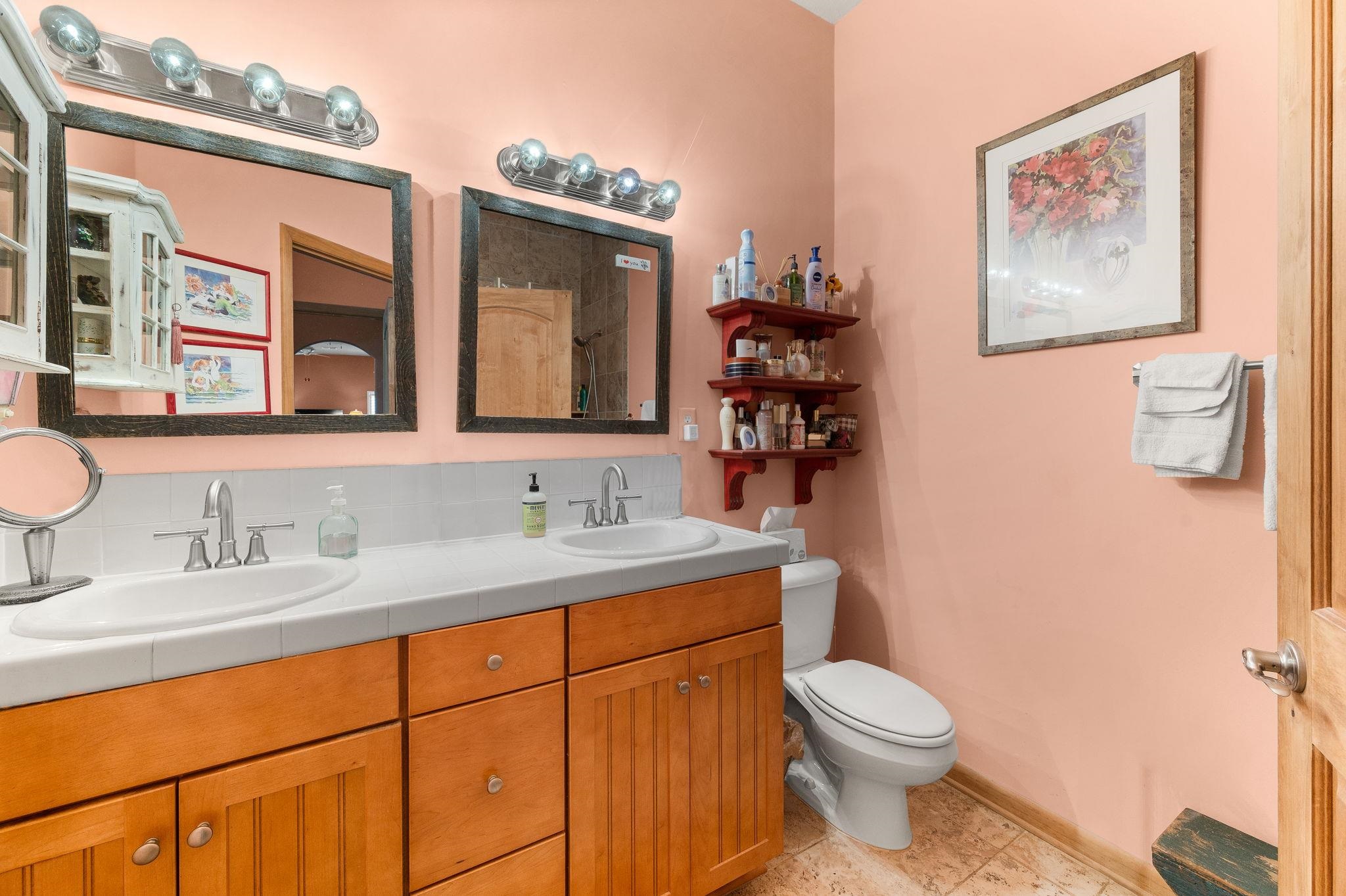 99 Grand Ravine Drive St. Augustine, FL 32086 - Photo 32 of 42 a bathroom with a toilet a sink and mirror