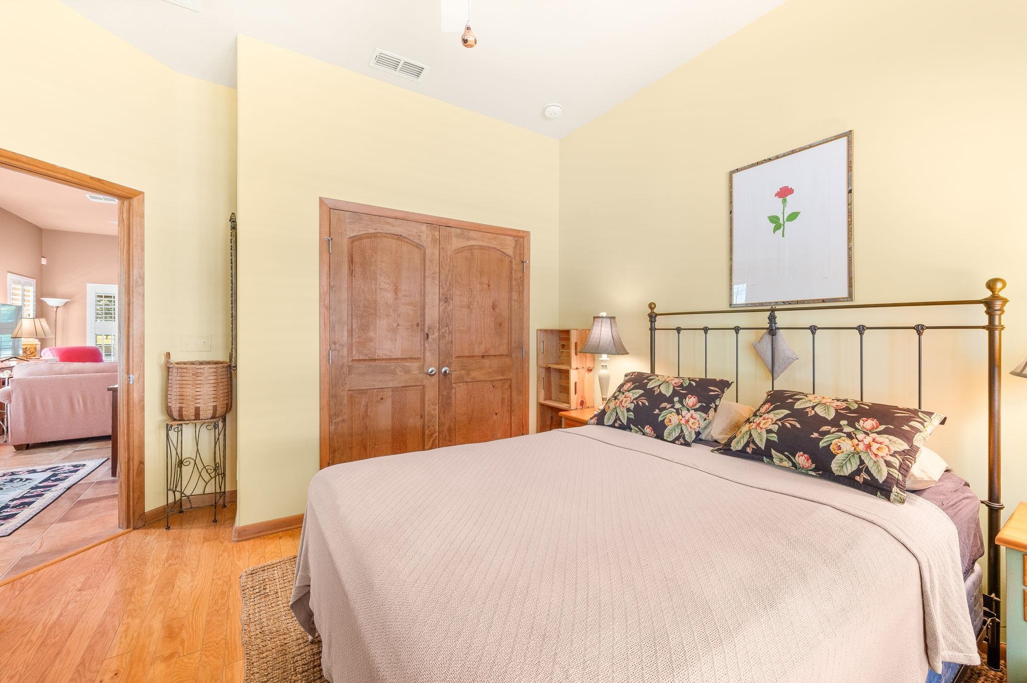 99 Grand Ravine Drive St. Augustine, FL 32086 - Photo 36 of 42 a bedroom with a bed and wooden floor