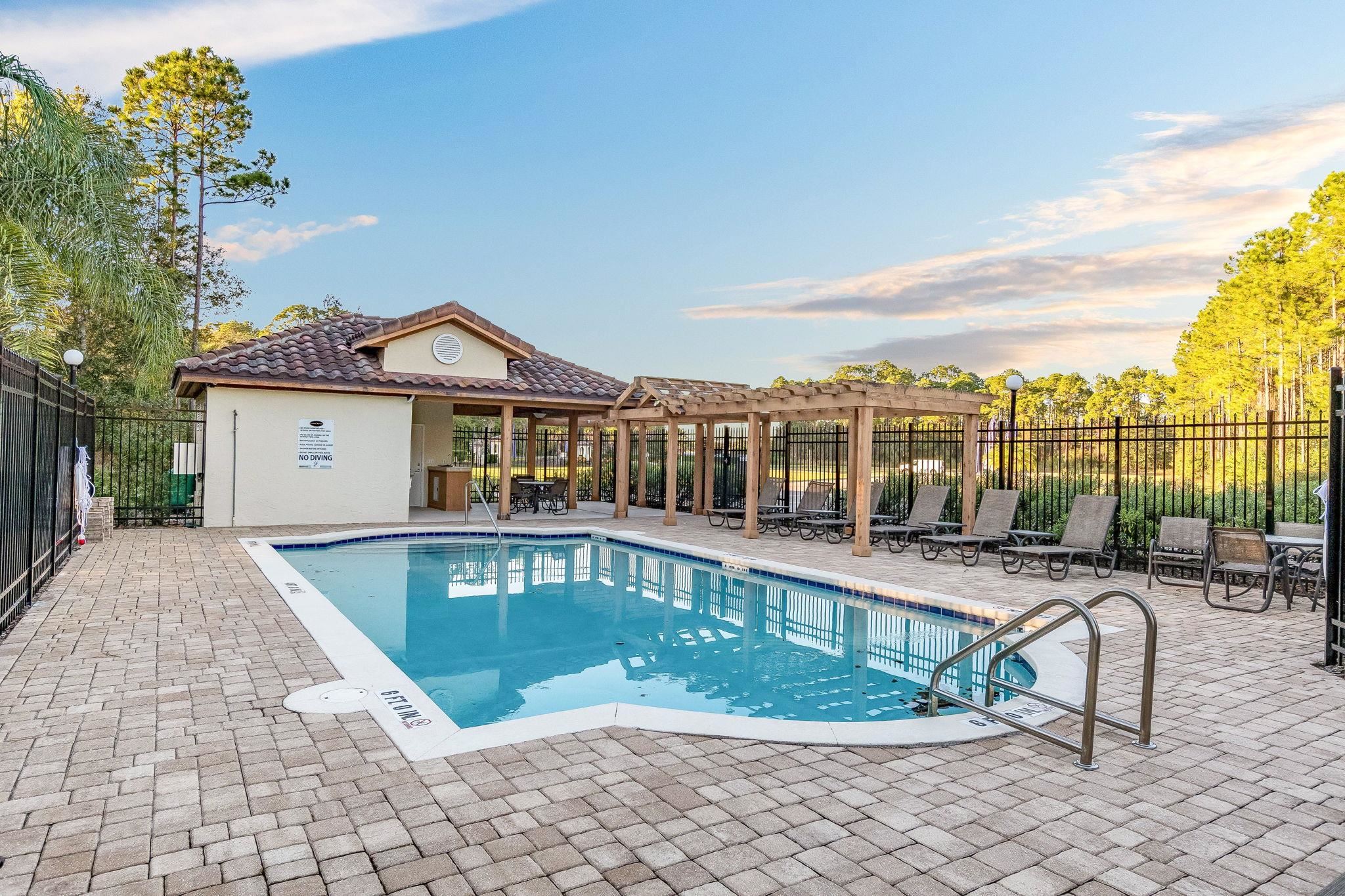 99 Grand Ravine Drive St. Augustine, FL 32086 - Photo 6 of 42 a front view of a house with swimming pool and porch