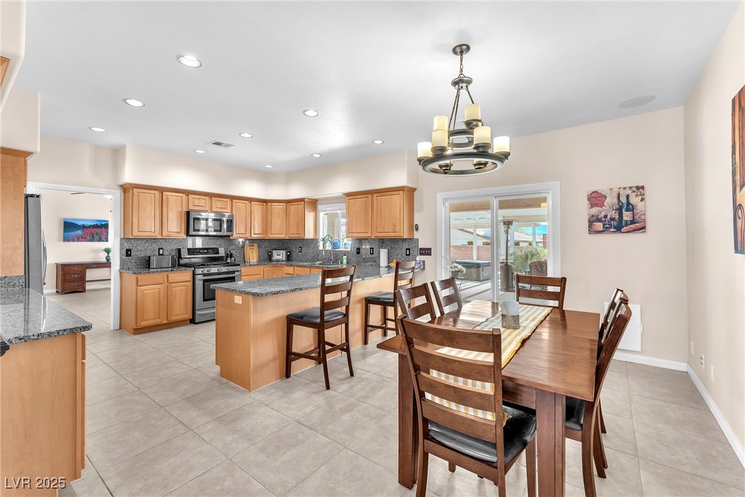 2251 Thoroughbred Road Henderson, NV 89002 - Photo 10 of 60 Dining area featuring a chandelier, light tile patterned floors, and recessed lighting