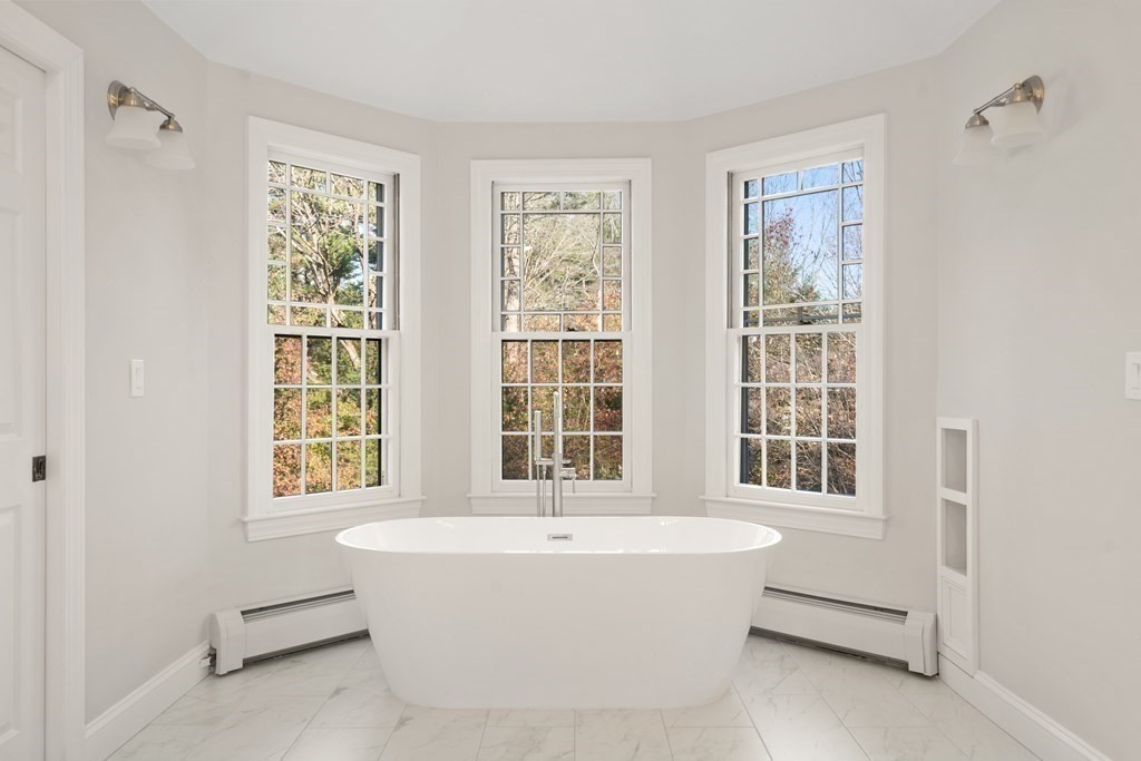 105 Plain Road Wayland, MA 01778 - Photo 19 of 25 a white bath tub sitting next to a window
