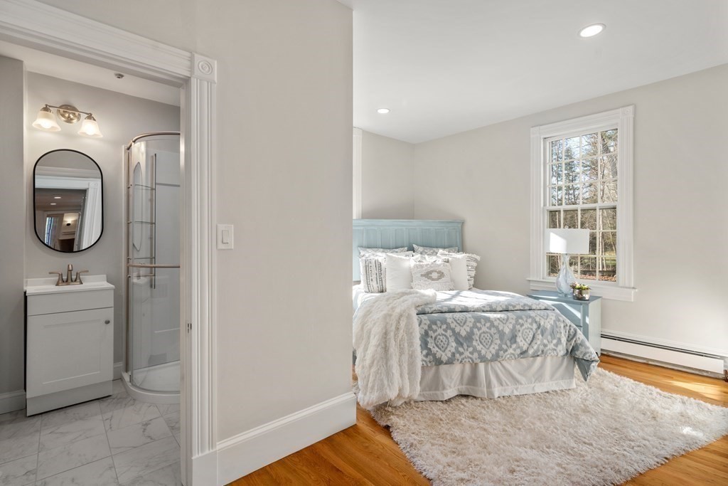 105 Plain Road Wayland, MA 01778 - Photo 20 of 25 a bedroom with a bed and a mirror