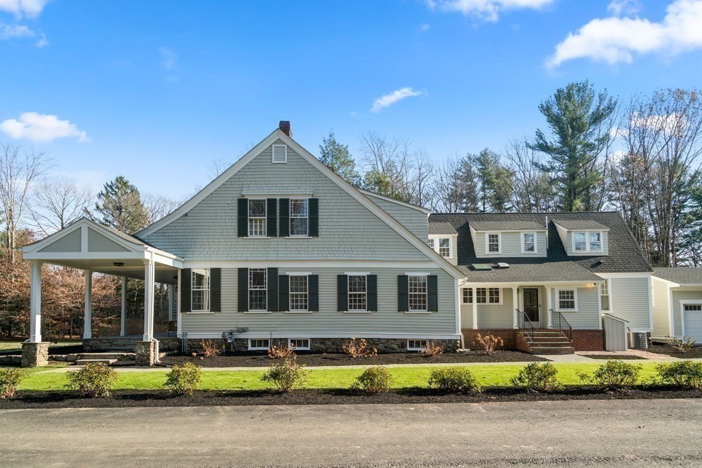 105 Plain Road Wayland, MA 01778 - Photo 23 of 25 a front view of a house with a garden and plants