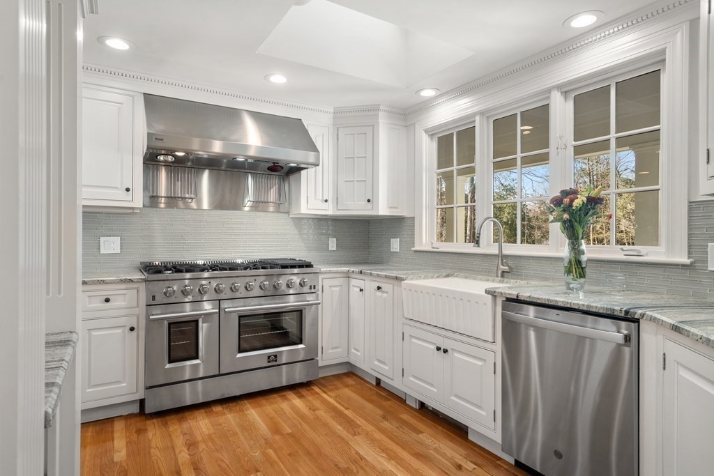 105 Plain Road Wayland, MA 01778 - Photo 3 of 25 a kitchen with stainless steel appliances granite countertop a stove and a sink