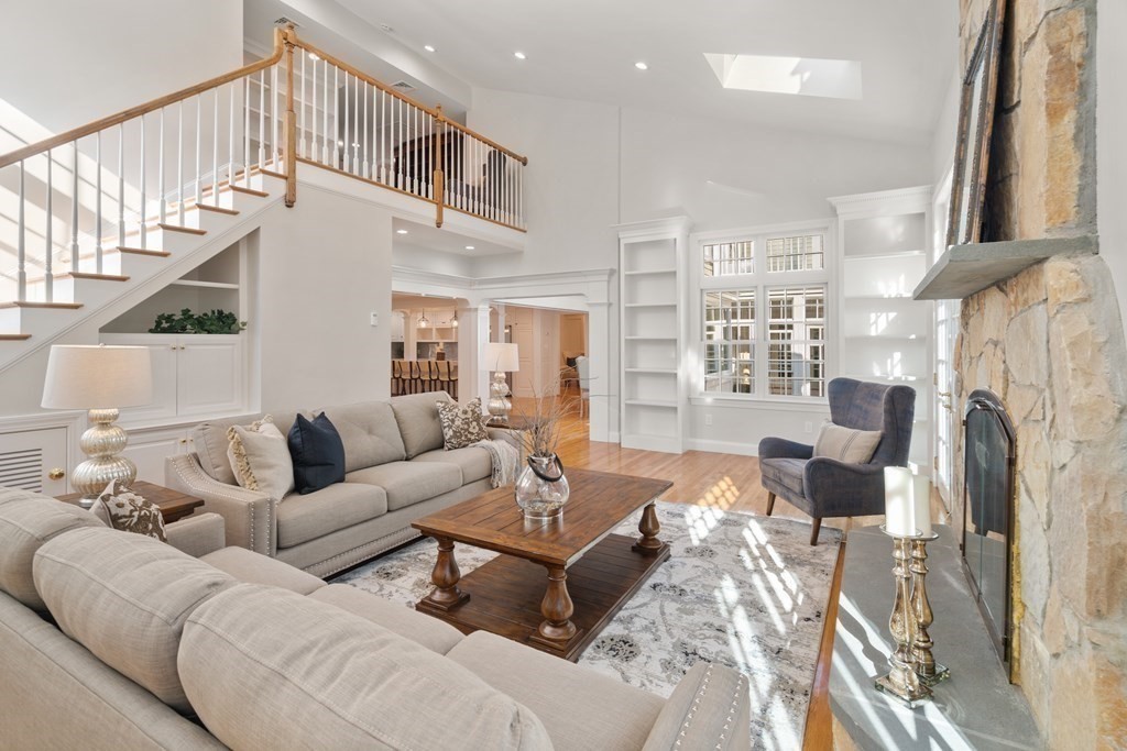 105 Plain Road Wayland, MA 01778 - Photo 7 of 25 a living room with furniture a fireplace and a large window