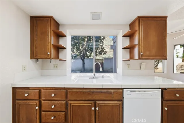 a kitchen with sink cabinets and window