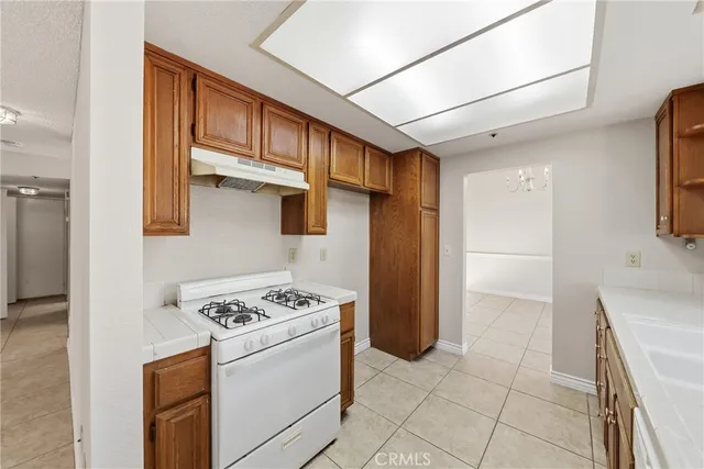 a kitchen with stainless steel appliances granite countertop a refrigerator and a stove