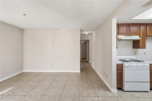 a kitchen with a stove top oven and cabinets