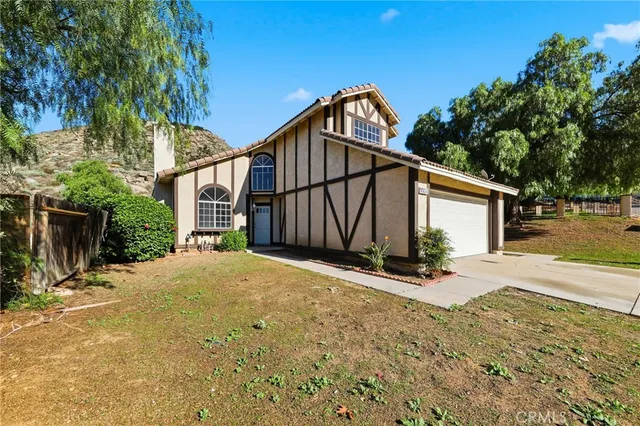 a view of a house with wooden fence next to a road