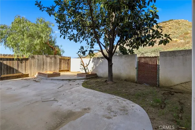 a view of a house with wooden fence and a porch