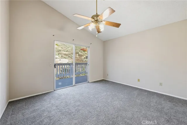 an empty room with closet and a ceiling fan