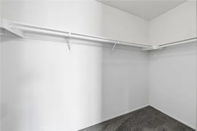 a view of empty room with window and ceiling fan