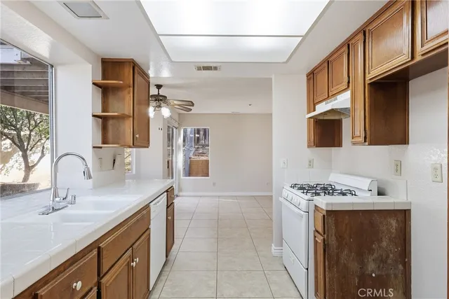 a kitchen with stainless steel appliances granite countertop a sink stove and cabinets