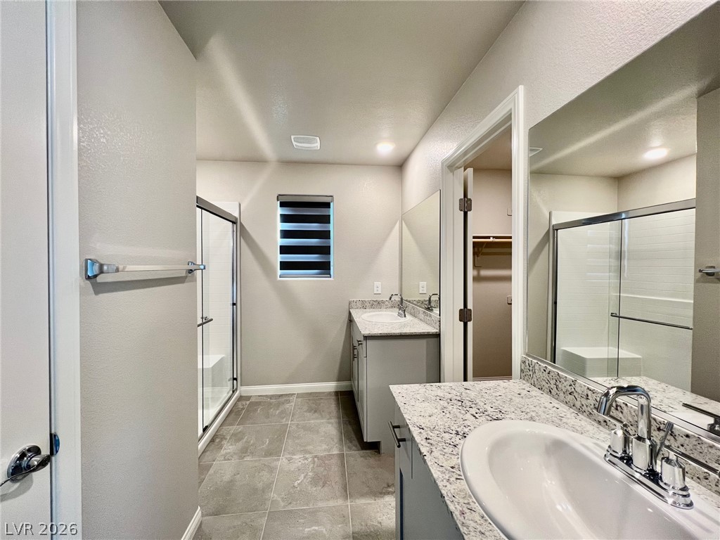 7845 Morganite Avenue Las Vegas, NV 89113 - Photo 16 of 21 Granite counters and dual vanities elevate this well-appointed bathroom.
