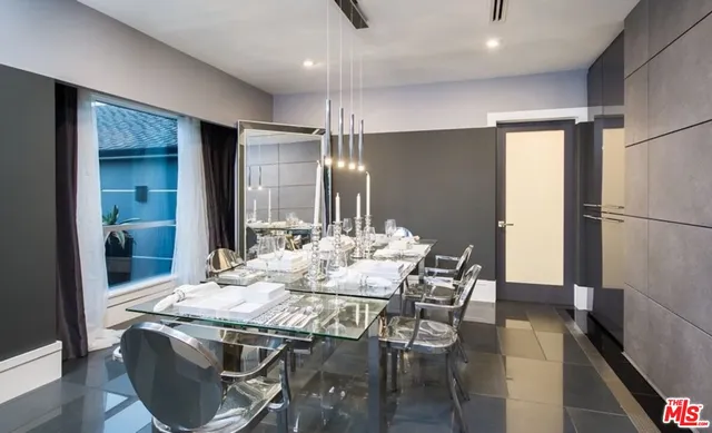 a kitchen with stainless steel appliances granite countertop table chairs and refrigerator