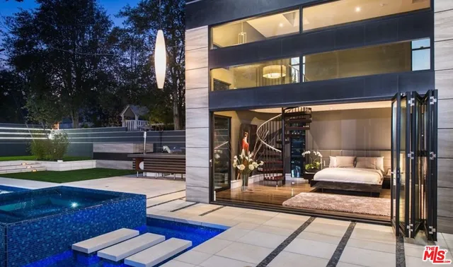 a bedroom with bed and a large window