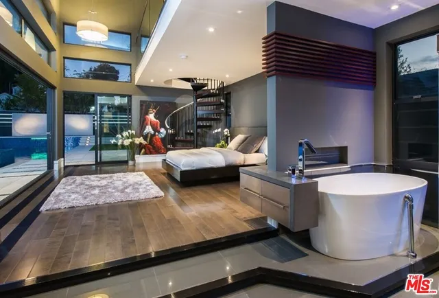 a living room with patio furniture and a flat screen tv