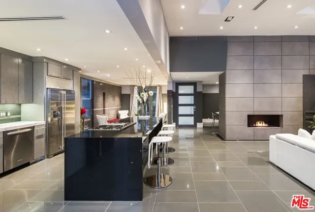 a kitchen with stainless steel appliances kitchen island granite countertop a sink and cabinets