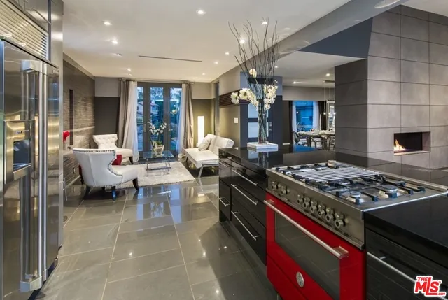 a kitchen with stainless steel appliances granite countertop a stove top oven and cabinets