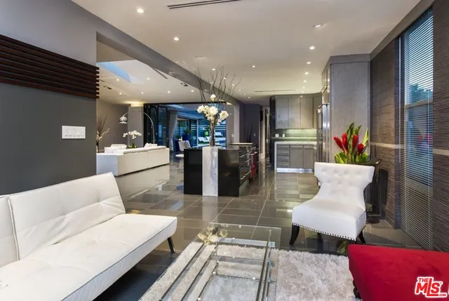 a living room with furniture kitchen view and a couch