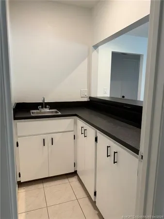 a kitchen with a sink and cabinets